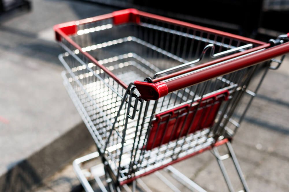 an empty red and silver shopping cart